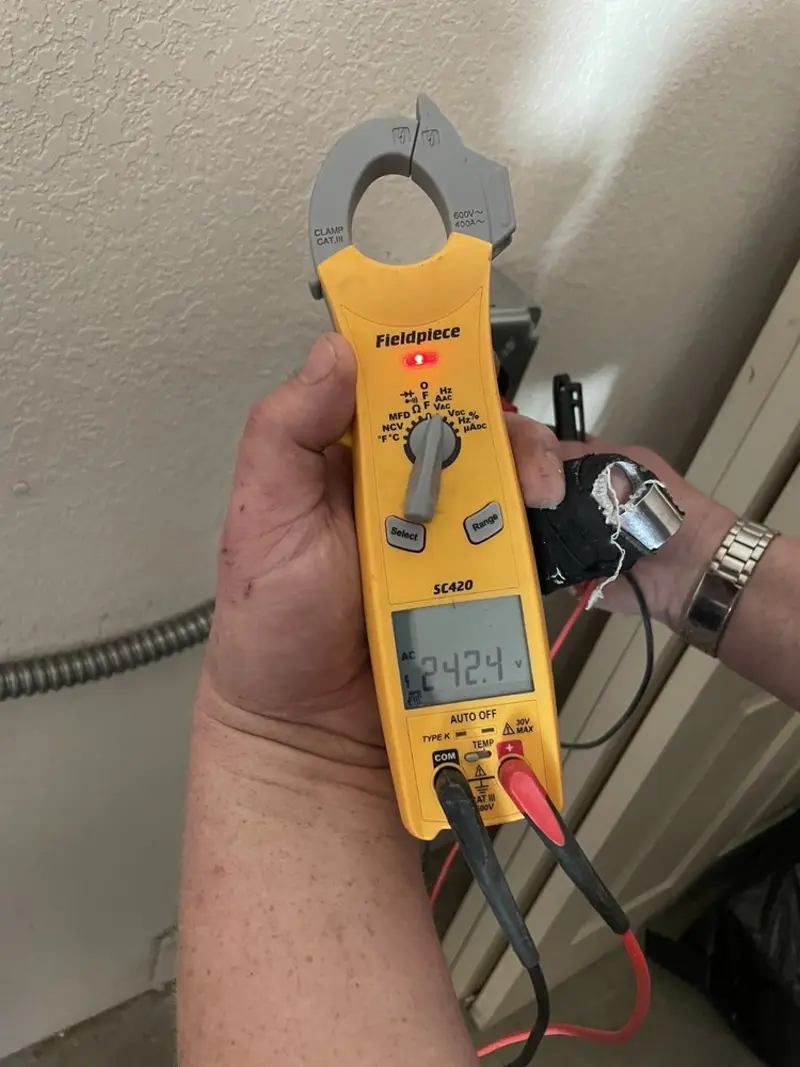 Voltage testing with clamp meter during Generator Installation in Pompano Beach